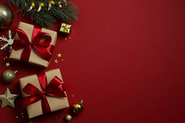 istock Festive gift boxes tied with bows, Christmas decorations, confetti on color background 2250336811