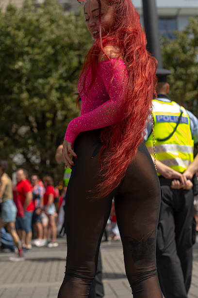 istock chic figure dressed in pink meshes walks confidently through bustling parade with onlookers 2250342817