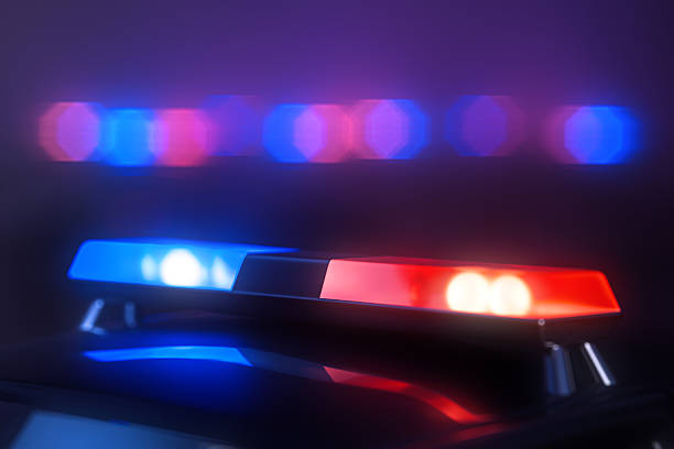 istock Police car flashing red and blue lights at night 2250346413