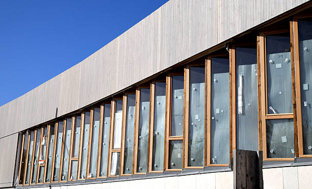 Glass building. Windows made of glass. Modern building in the city. Steel cornice.
