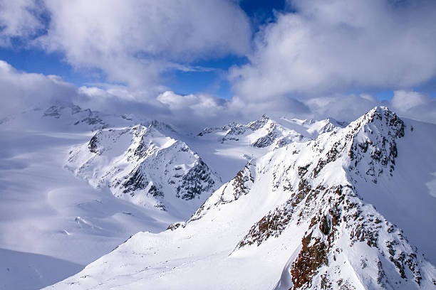 Snowy Alpine Mountain Peaks Under Blue Sky
