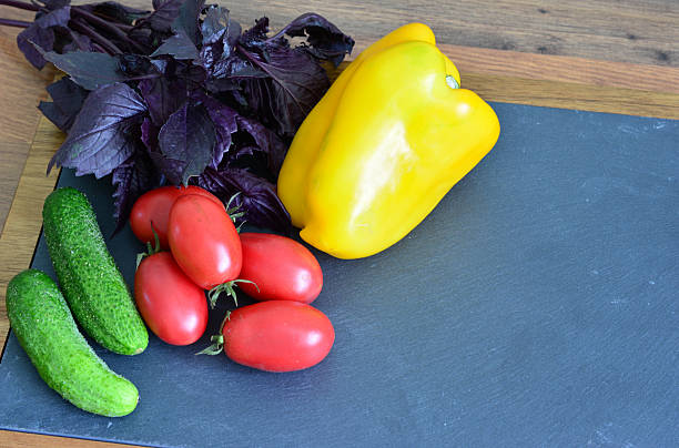 Colorful Harvest Bell Pepper, Tomatoes, Cucumbers and Basil blank space