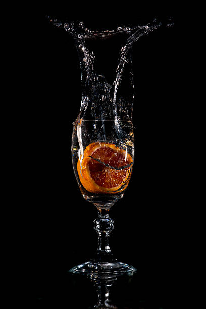 istock Orange segment dropped into the glass 2250358197