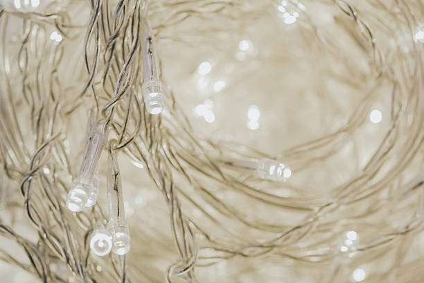 Warm White String Lights. Shiny wallpaper with garlands in warm light tones.