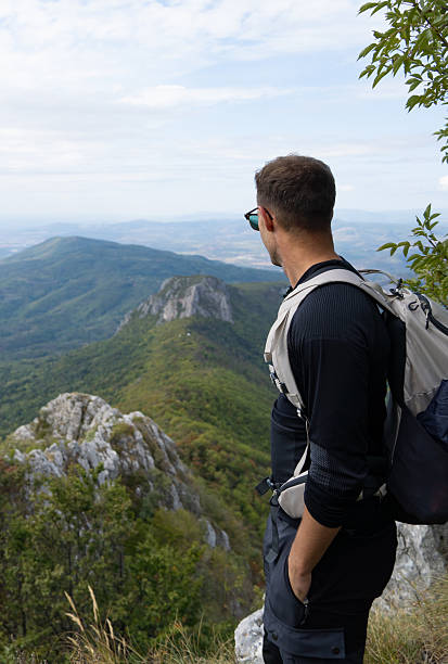 istock Man looking at the mountain ridge covered with lush forest. 2250361077