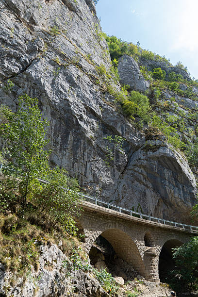istock Old stone bridge in the canyon. Steep cliffs behind 2250361540