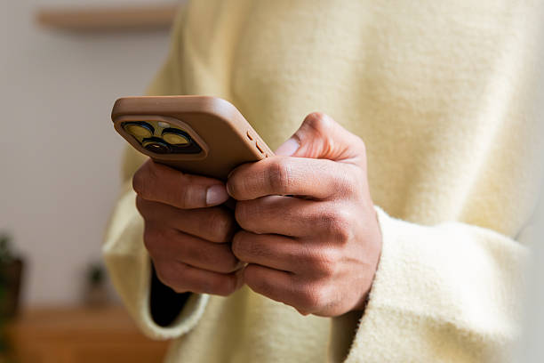 istock Person holding smartphone texting message communicating online 2250363753