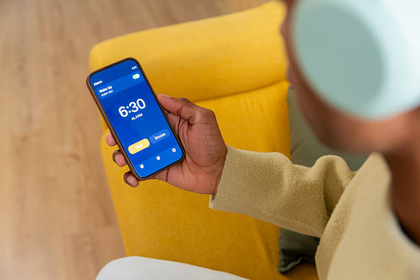 istock Person holding smartphone checking alarm in morning 2250363834