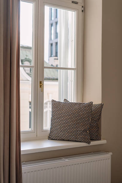 istock Cozy windowsill with decorative cushions in a modern living room space 2250364662