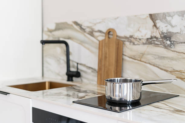 istock Modern kitchen with marble countertop and cooking pot on stove 2250364691