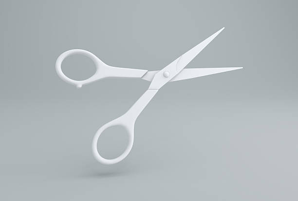 A spool of blue thread sits on a surface with scissors blurred in the background, emphasizing a sewing craft scene