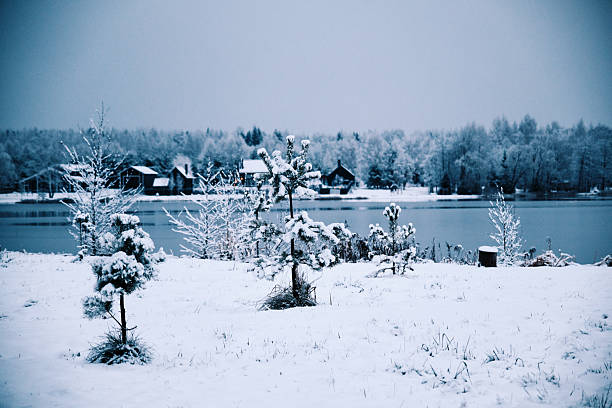 Snow on riverbank in summer village