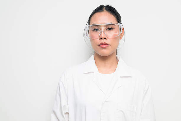 istock Female Scientist in Protective Goggles and Lab Coat on White Background 2250371976