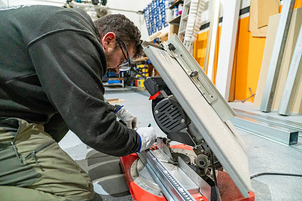 istock Worker measuring metal profile before cutting with miter saw 2250376700