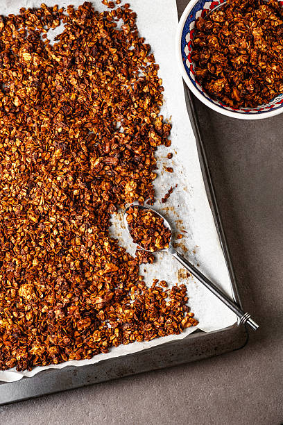 istock Homemade Crunchy Granola on Baking Sheet with Spoon. 2250377117