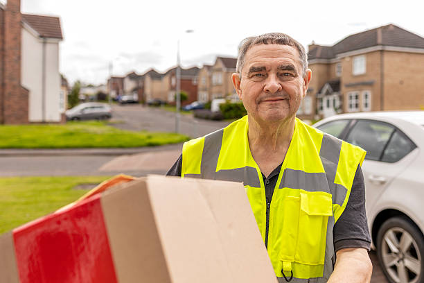 istock Courier Approaching Home While Carrying Online Shopping Parcel for Delivery 2250381354