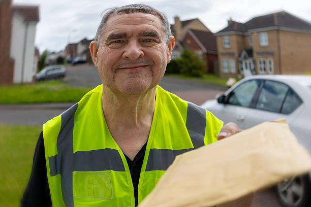 istock Distorted and Blurry Doorbell Camera Angle of Courier Presenting Padded Mailer 2250381450