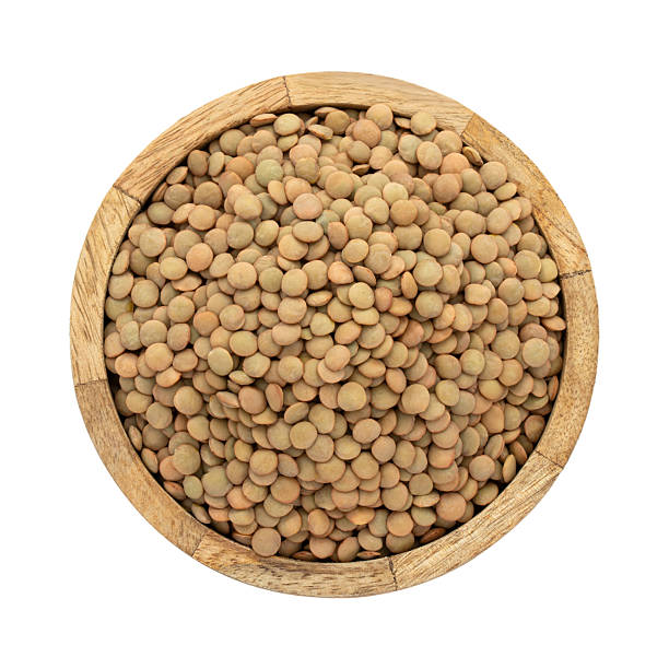 istock wooden plate with green lentils on white isolated background 2250381752