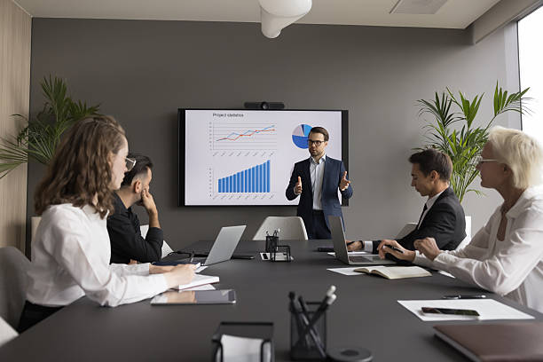 istock Male coach hold seminar for staff explaining infographic data 2250384414
