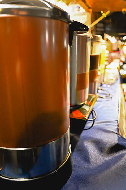 Coffee urns and thermos on a catering buffet, keeping drinks available and warm