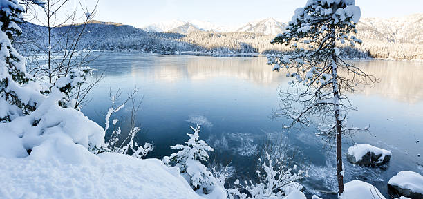 istock Winter trees and mountain reflection in the lake 2250391286