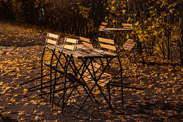 Stockholm, Sweden Outdoor tables and chairs in a park on autumn night.
