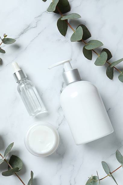 istock Natural cosmetic products with eucalyptus leaves on marble background, top view 2250393665