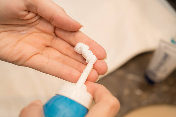 istock Hand Applying Dermatology Foam Product on Palm 2250394306