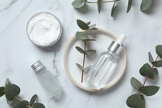 istock Natural cosmetic products with eucalyptus leaves on marble background, top view 2250395212