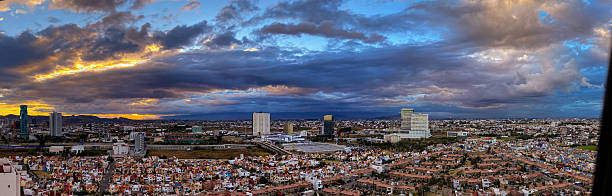 Puebla City, Mexico State - Panoramic Cityscape Under Dramatic Storm Clouds and Golden Sunset