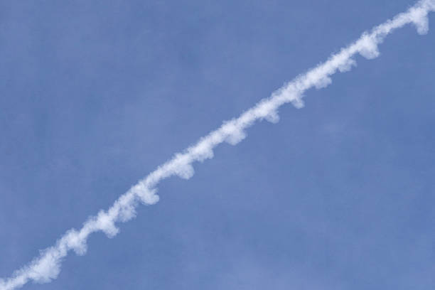 istock Unique abstract background and texture image created by looking up at the white contrail of an airplane in a clear blue sky. 2250403843