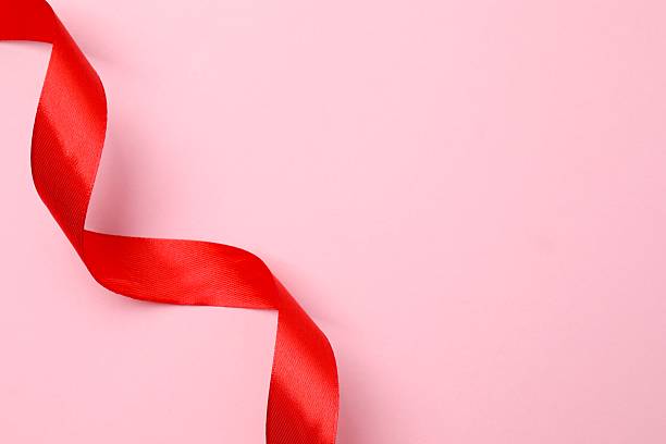 istock Red silk ribbon on color background 2250411947