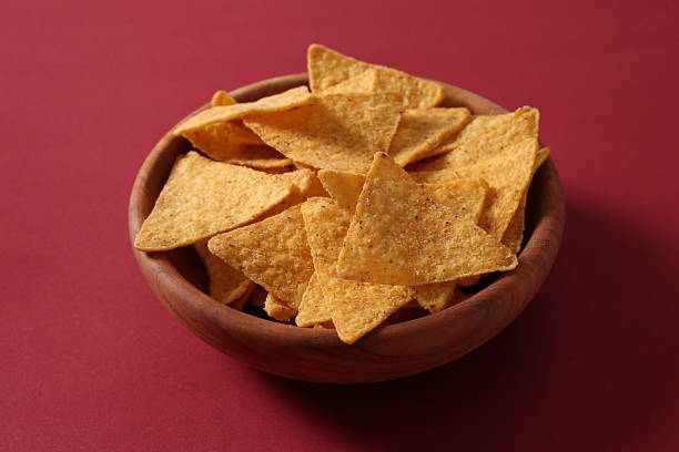 istock Tasty corn chips in a bowl on a colored background 2250412507