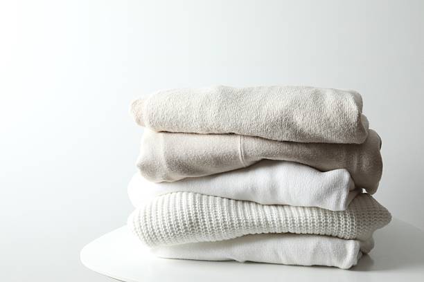 istock A stack of freshly washed, neatly folded clothing on a wooden table 2250413051