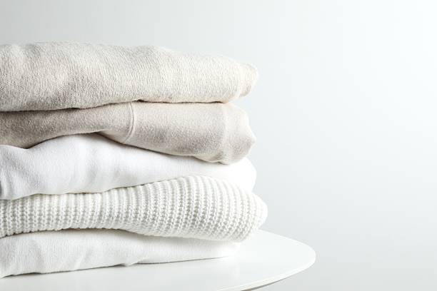 istock A stack of freshly washed, neatly folded clothing on a wooden table 2250413056