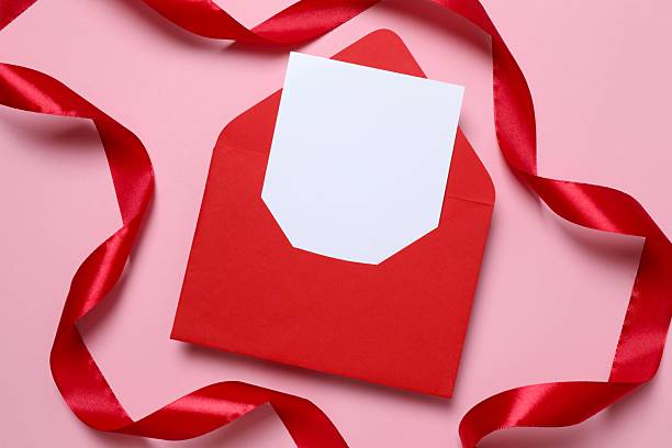 istock Red paper envelope with blank white note mockup inside and red ribbon on color background. Flat lay, top view. Romantic love letter for Valentine's day concept. 2250414117