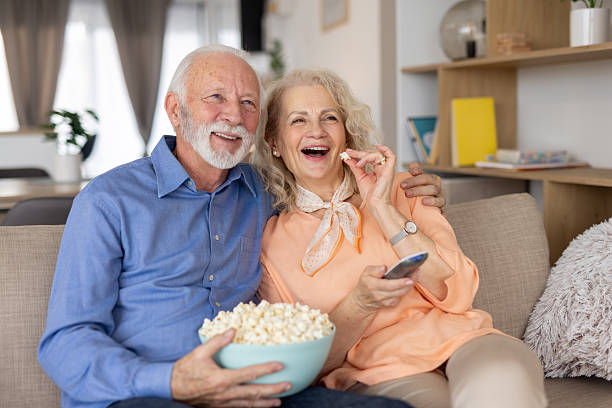 istock Elderly Couple Sharing Laughs Over Movie Time 2250420383