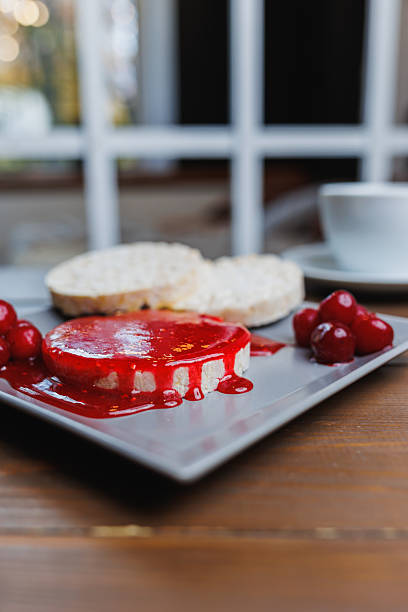Bruschetta with cherry jam. Appetizer with ricotta cheese, cream cheese, berry jam. Toast, sweet snack for breakfast