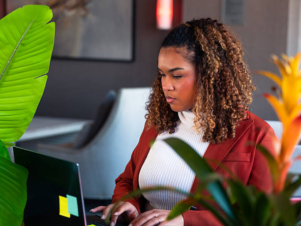 istock Focused Black Woman Working on Laptop in Office 2250432413