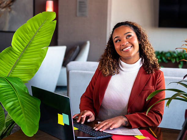 istock Black Woman Smiling While Working at Laptop 2250432455