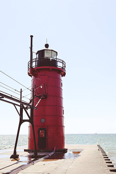 istock A bright red lighthouse stands on a pier along Lake Michigan 2250437192