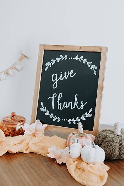 istock Chalkboard with text Give Thanks autumn leaves, pumpkins, fall home decor. Thanksgiving 2250437273