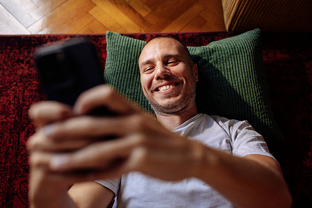 istock Man taking a cheerful selfie on the rug 2250438276