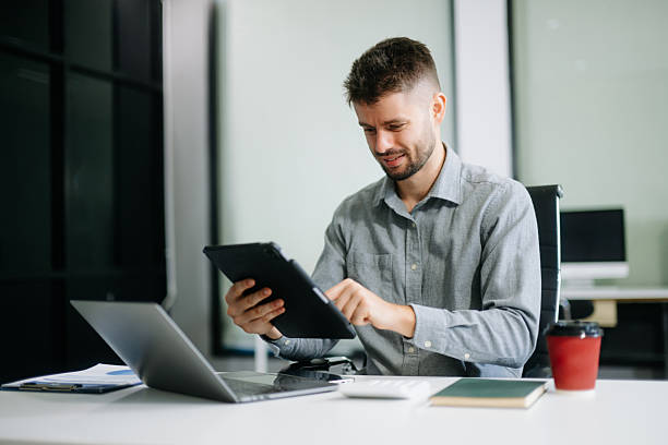 istock business man executive manager looking at laptop watching online webinar training or having virtual meeting video conference 2250439495