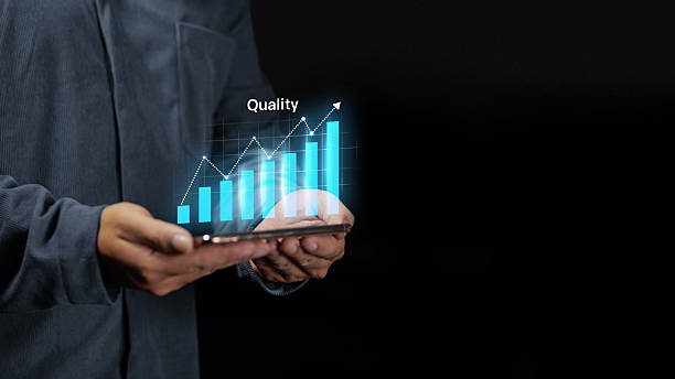 istock Hand holding tablet with rising quality graph and growth bar chart 2250440448