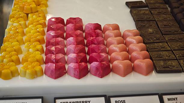 Chocolate bonbons in glass cabinet.