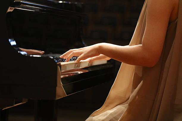 istock Woman playing the piano 2250443713