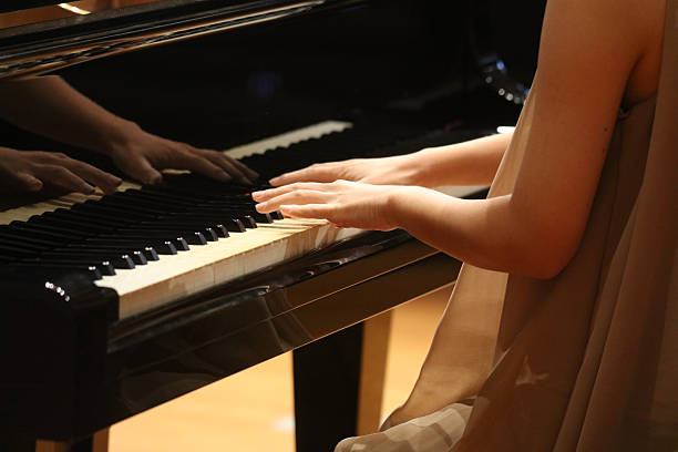 istock Woman playing the piano 2250443714