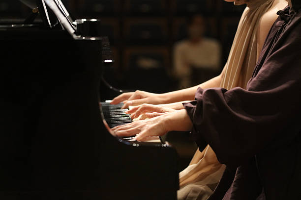 istock Woman playing the piano 2250443717