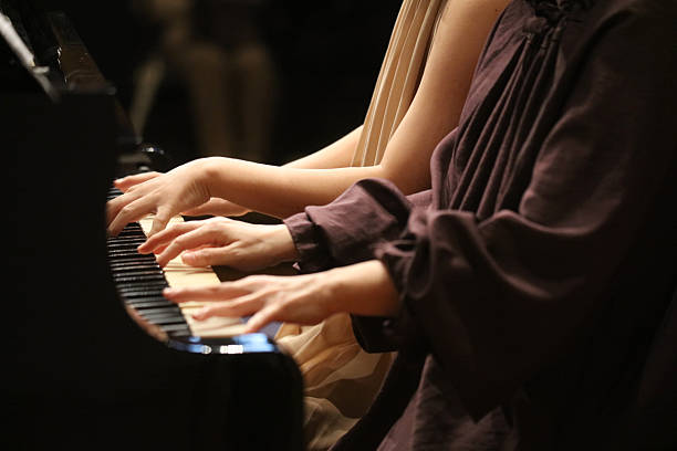 istock Woman playing the piano 2250443730